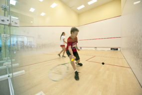 Cameron Burton goes for a forehand against Cameron Munn during the squash summer camp at the Elmaleh-Stanton Squash Center at the SYS facility in Southampton on Monday, 7/2/12