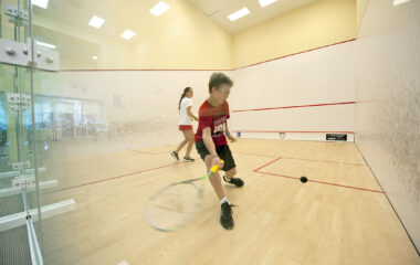 Cameron Burton goes for a forehand against Cameron Munn during the squash summer camp at the Elmaleh-Stanton Squash Center at the SYS facility in Southampton on Monday, 7/2/12